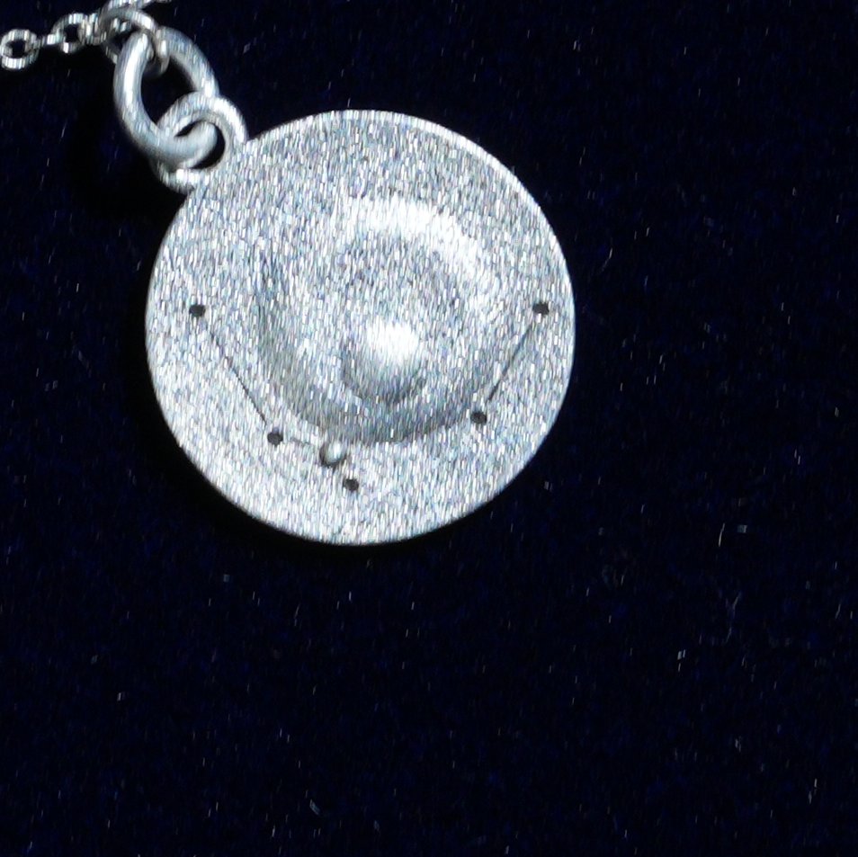 Coin of AV-0011, engraved with the Aquarius constellation, close up