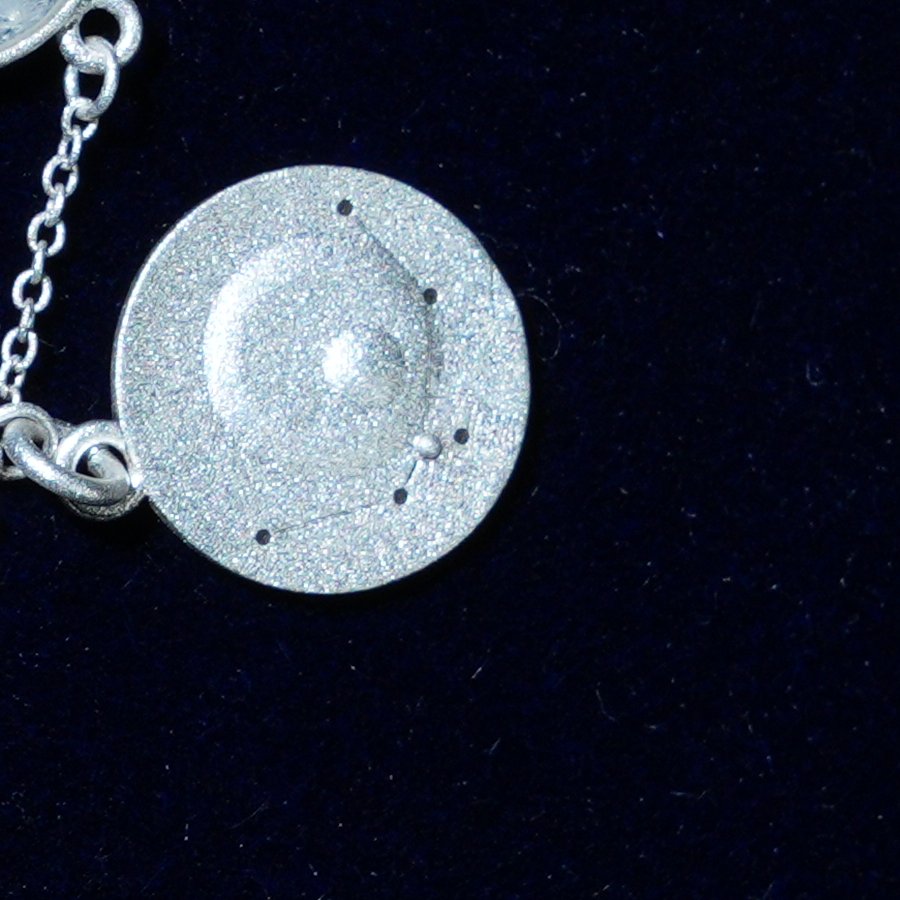 Coin of AV-0019, engraved with the Aquarius constellation, close up
