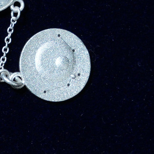 Coin of AV-0019, engraved with the Aquarius constellation, close up