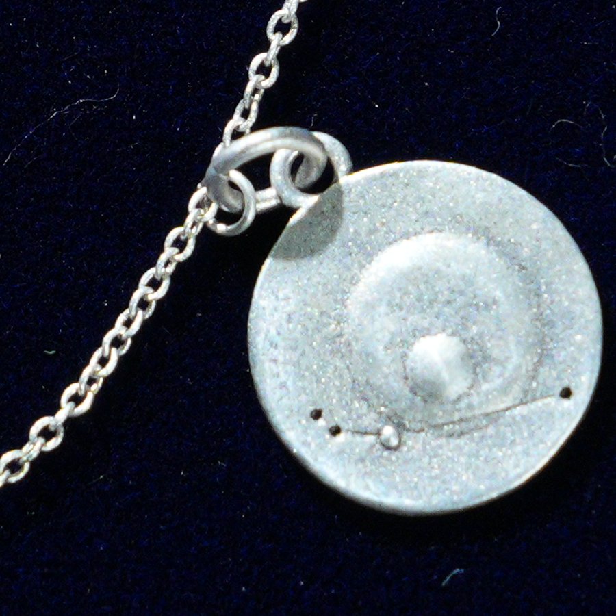 Coin of AV-0001, engraved with the Aries constellation, close up