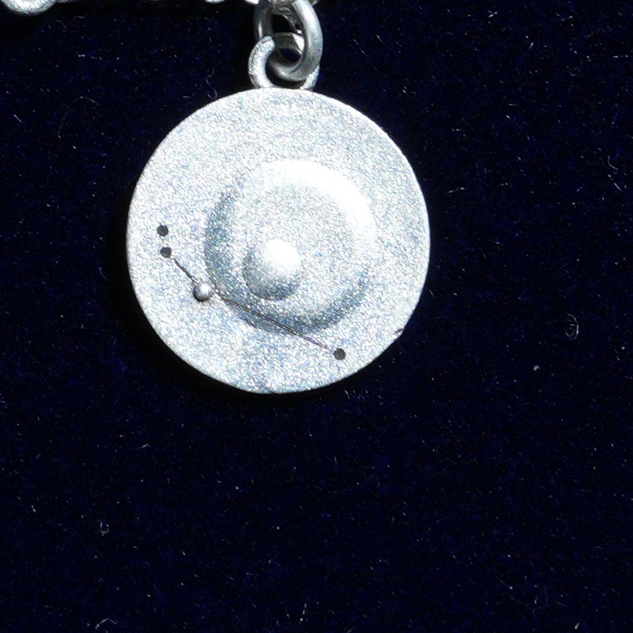 Coin of AV-0027, engraved with the Aries constellation, close up