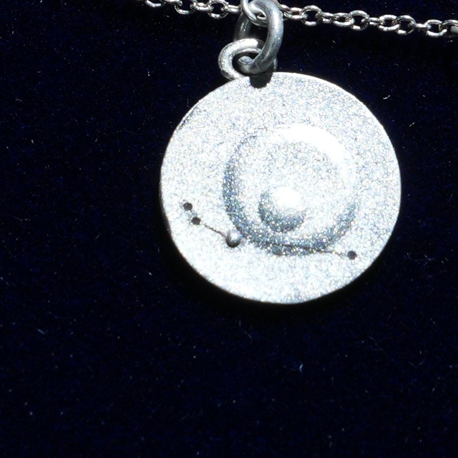 Coin of AV-0028, engraved with the Aries constellation, close up