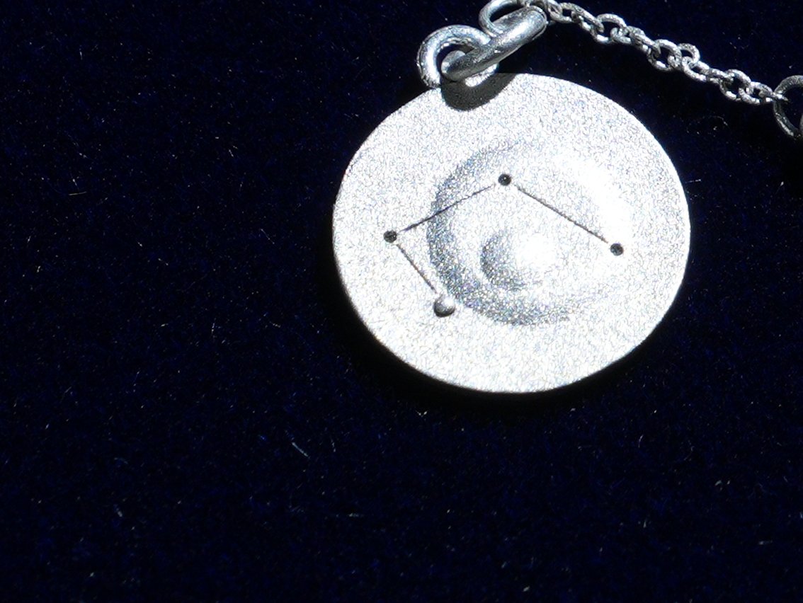 The Libra coin, engraved with the constellation, close up