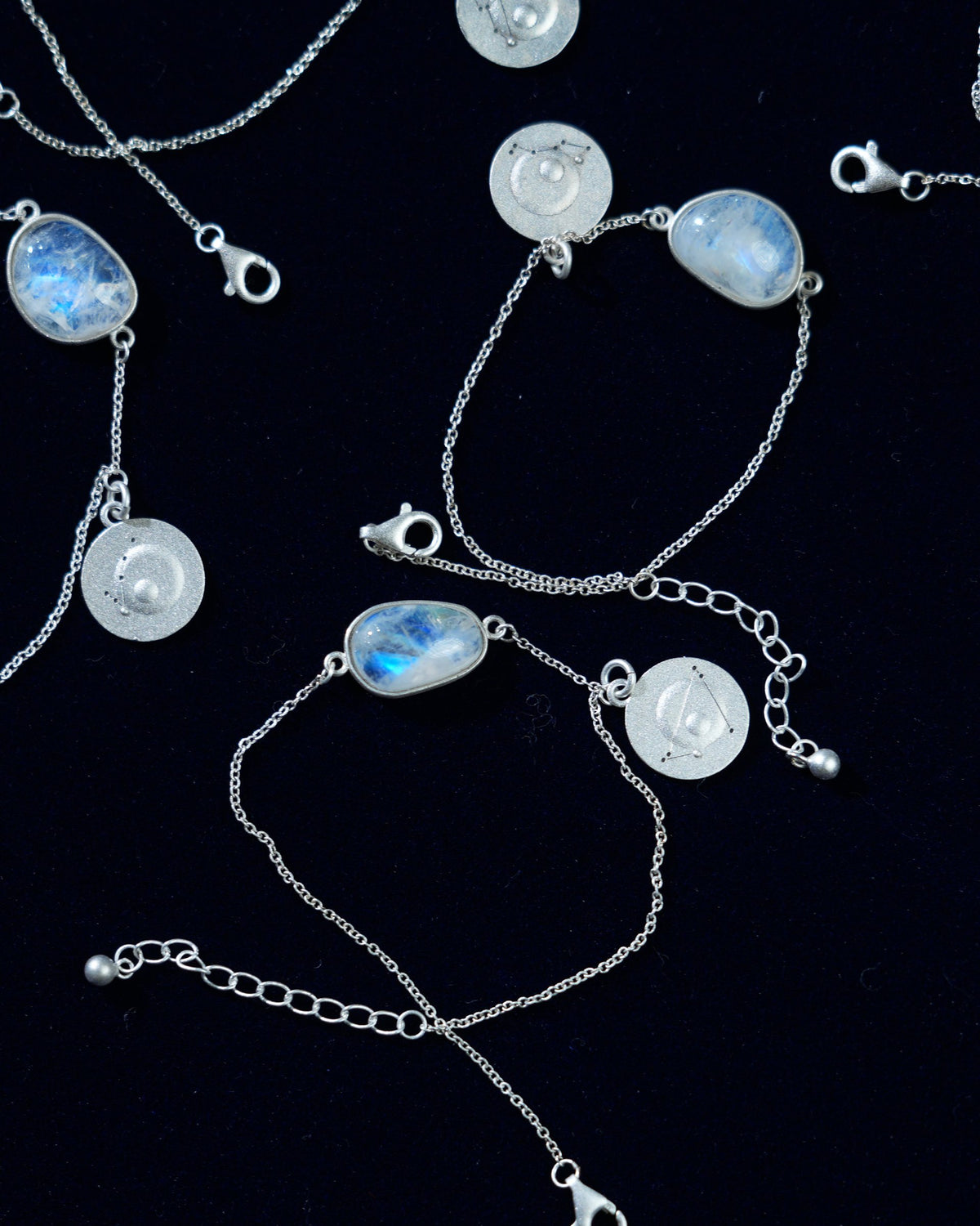Rainbow moonstone bracelets laid out, no two alike