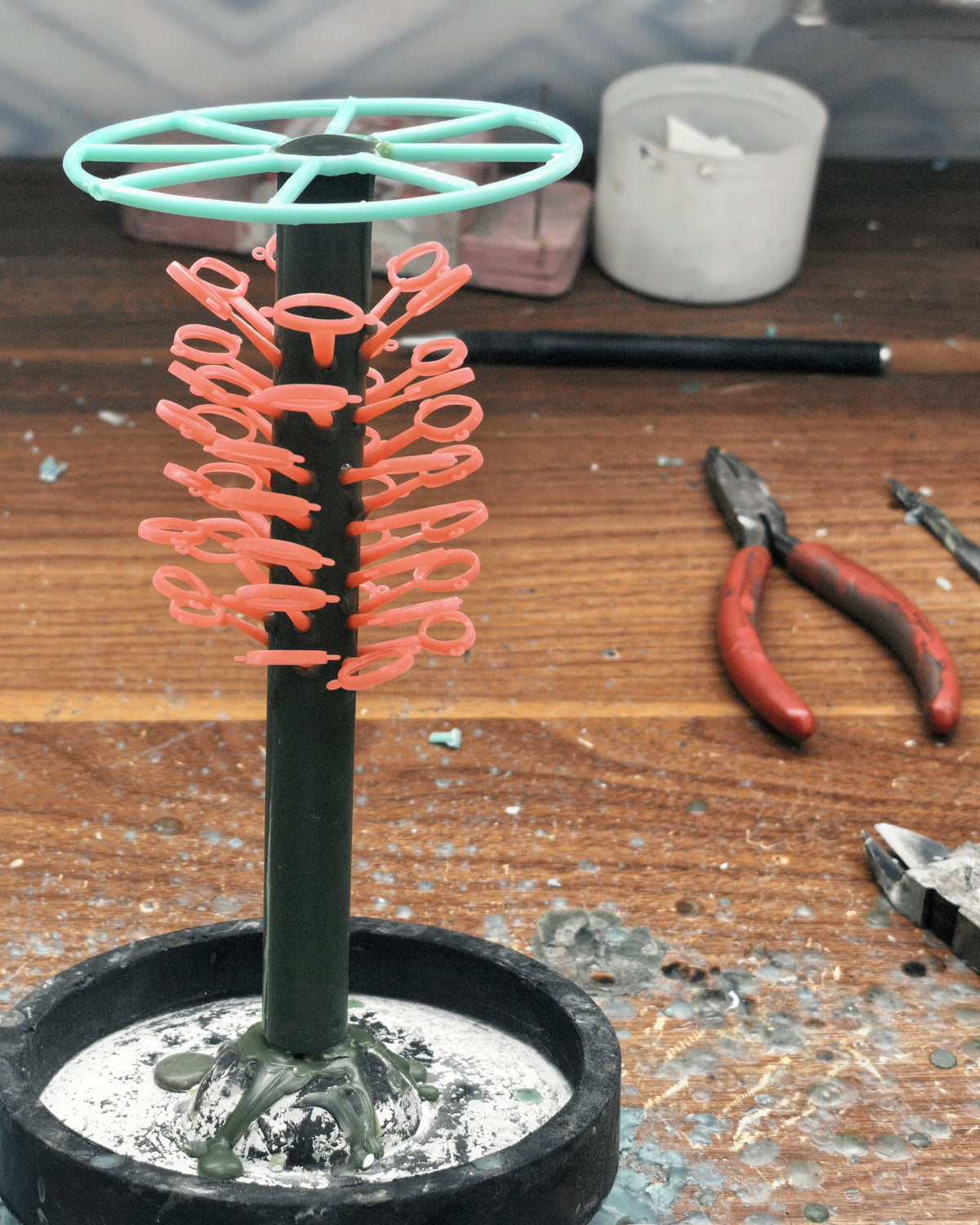 A jeweler's bench with a wax tree and tools