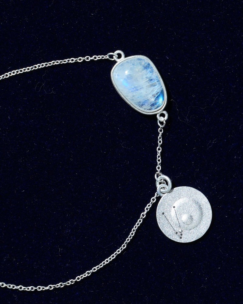 Rainbow moonstone and constellation coin of AV-0002, Taurus, close up
