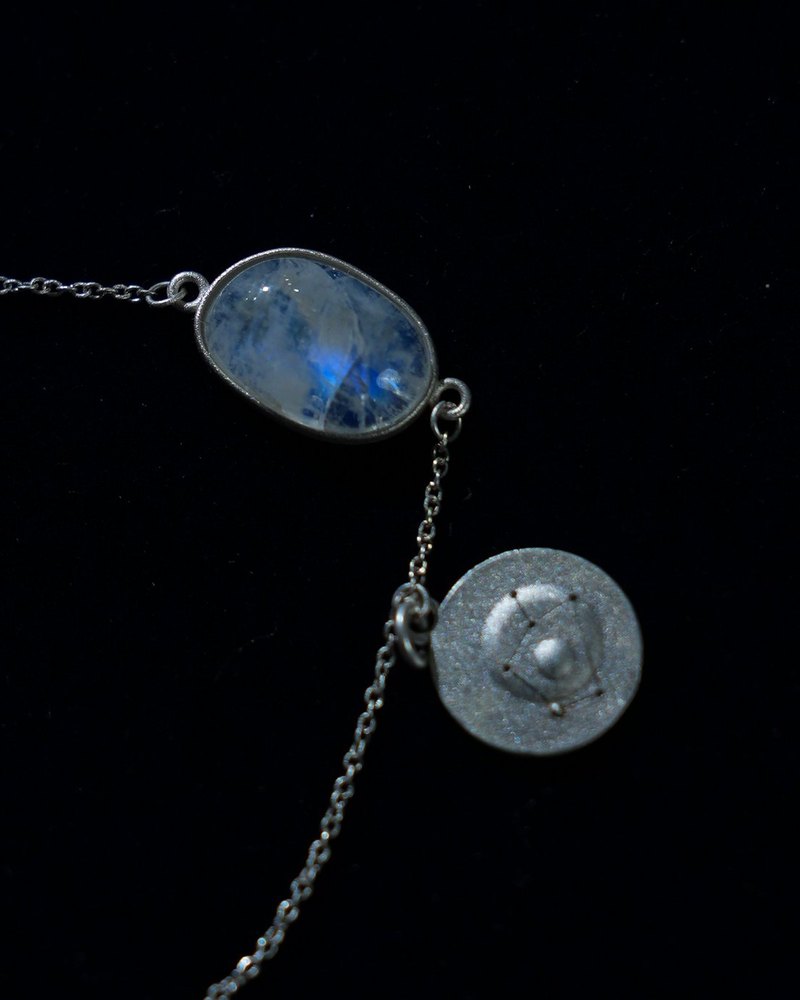 Rainbow moonstone and constellation coin of AV-0009, Sagittarius, close up