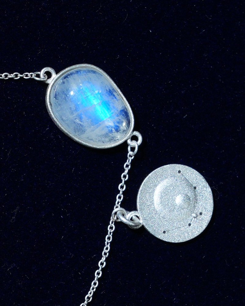 Rainbow moonstone and constellation coin of AV-0019, Aquarius, close up