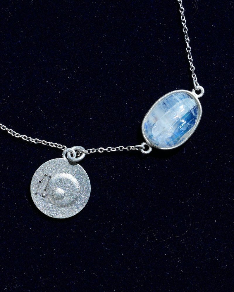 Rainbow moonstone and constellation coin of AV-0024, Gemini, close up