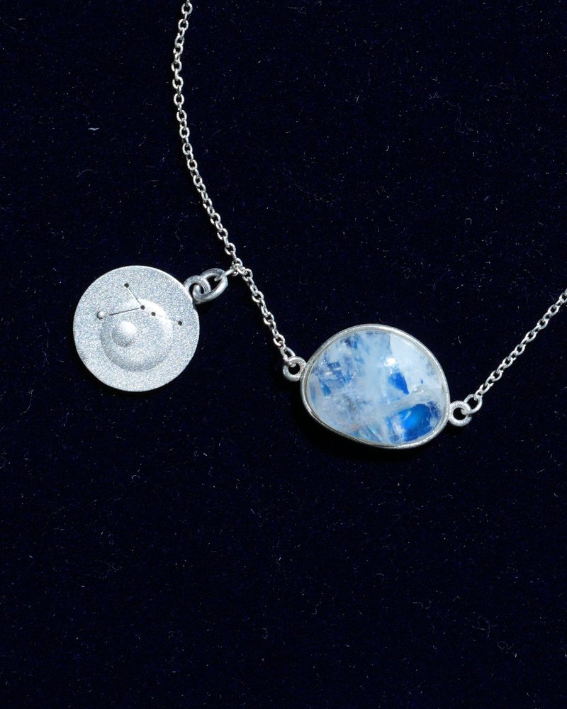 Rainbow moonstone and constellation coin of AV-0025, Cancer, close up