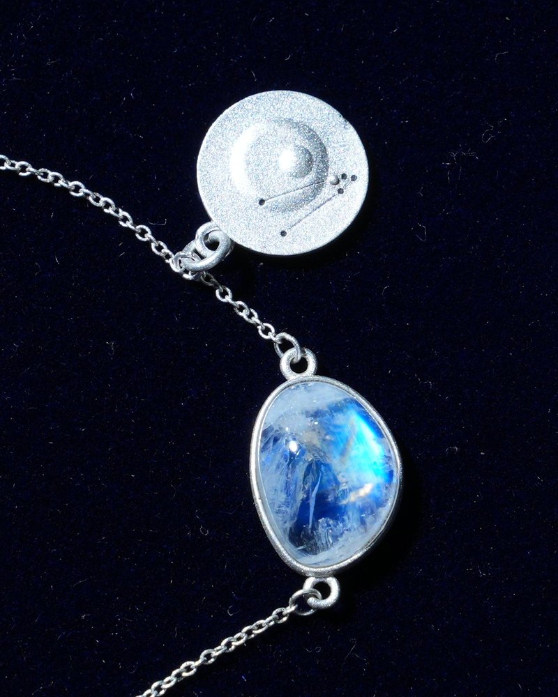 Rainbow moonstone and constellation coin of AV-0026, Taurus, close up