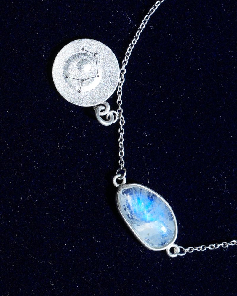 Rainbow moonstone and constellation coin of AV-0042, Sagittarius, close up
