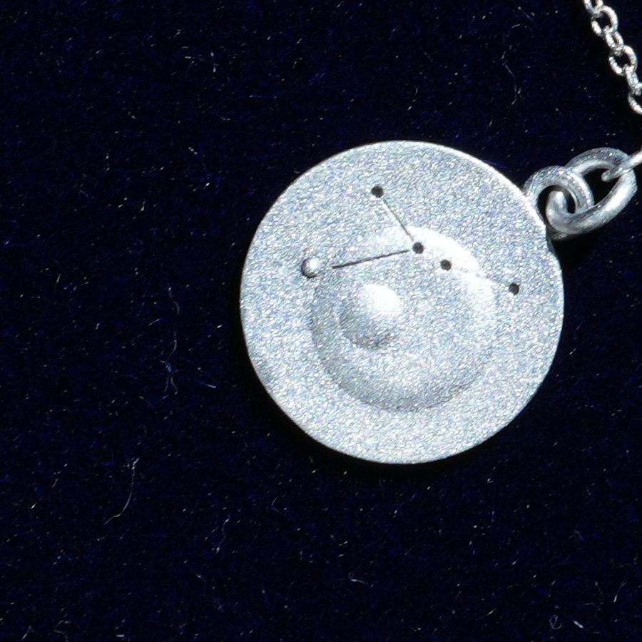 Coin of AV-0025, engraved with the Cancer constellation, close up