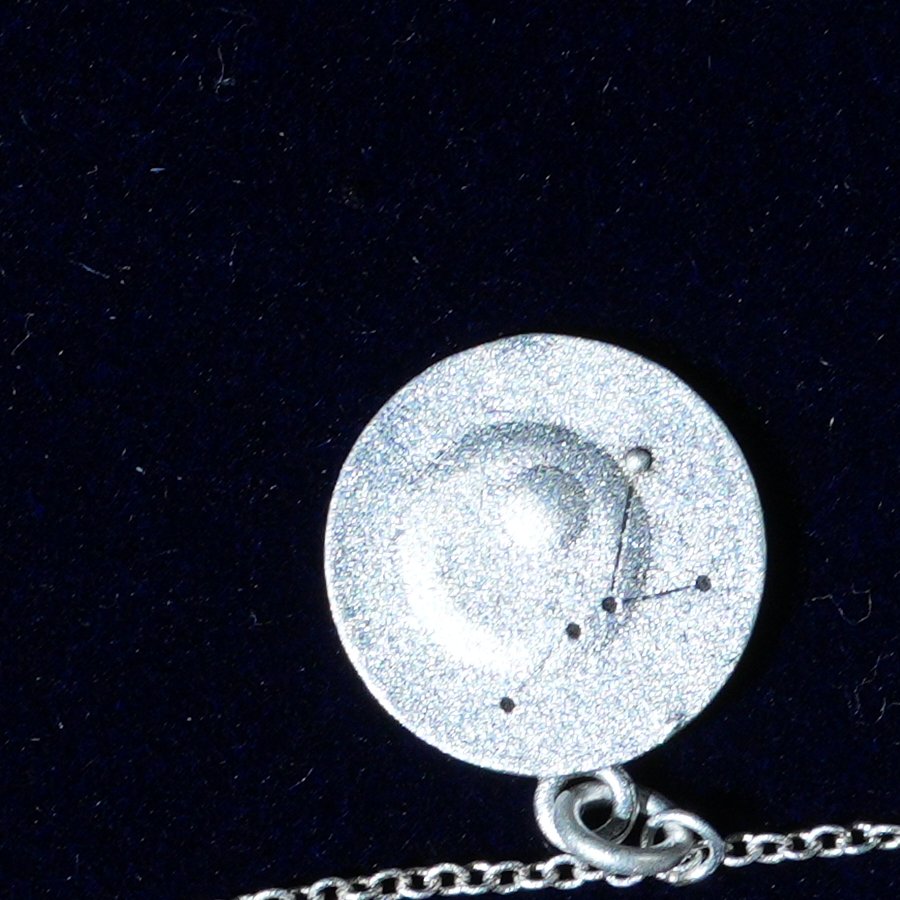 Coin of AV-0033, engraved with the Cancer constellation, close up