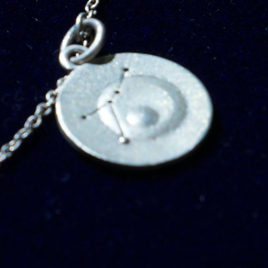 Coin of AV-0036, engraved with the Cancer constellation, close up