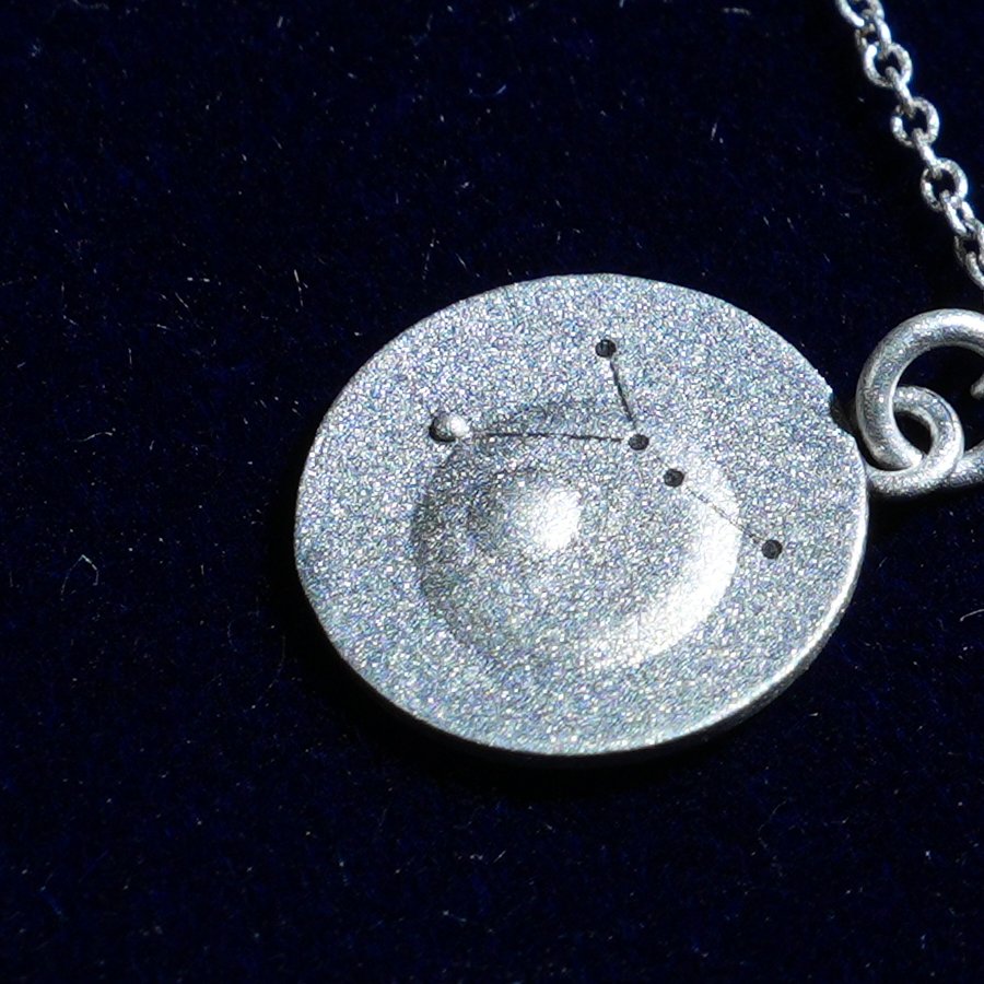 Coin of AV-0037, engraved with the Cancer constellation, close up
