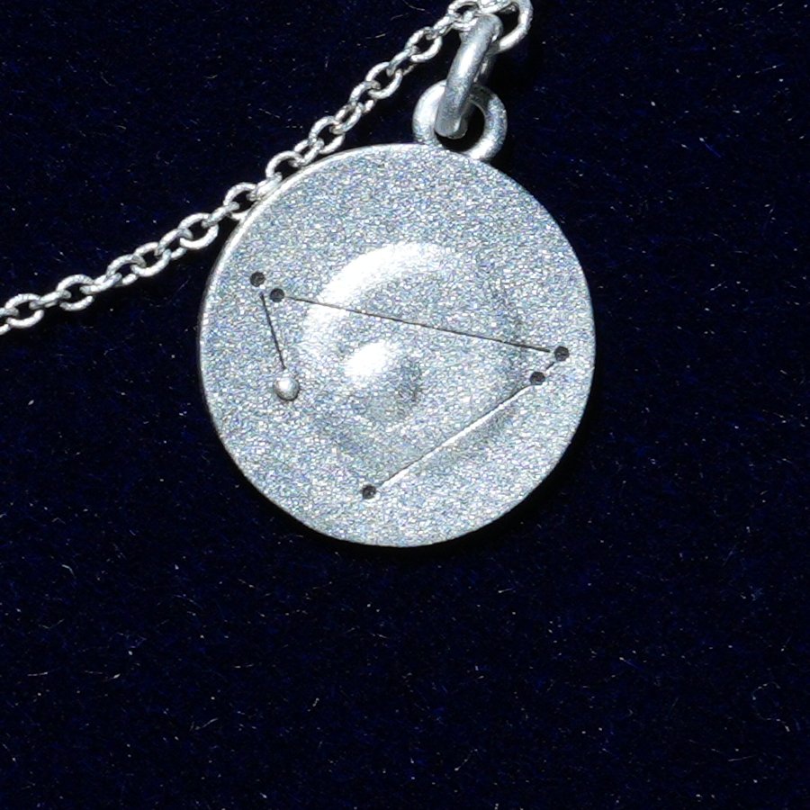 Coin of AV-0021, engraved with the Capricorn constellation, close up