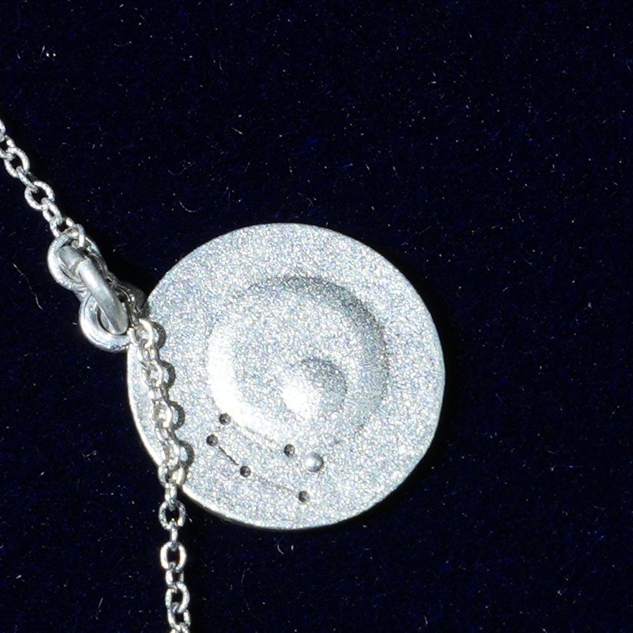 Coin of AV-0003, engraved with the Gemini constellation, close up
