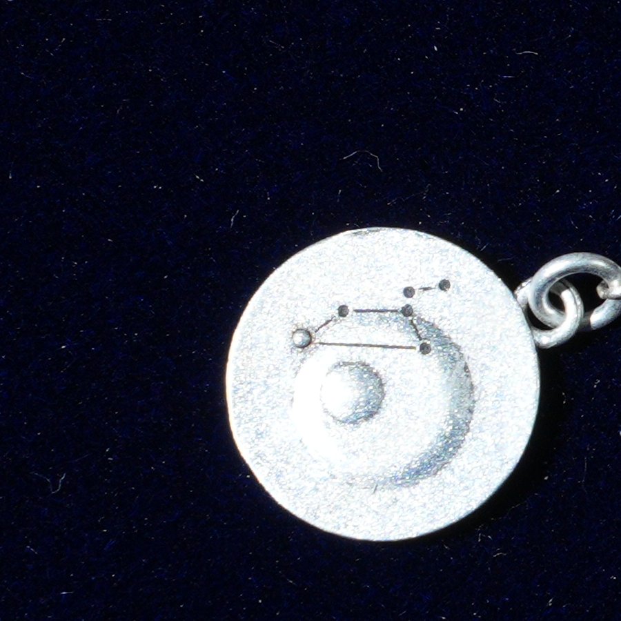 Coin of AV-0005, engraved with the Leo constellation, close up