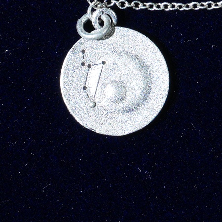 Coin of AV-0015, engraved with the Leo constellation, close up
