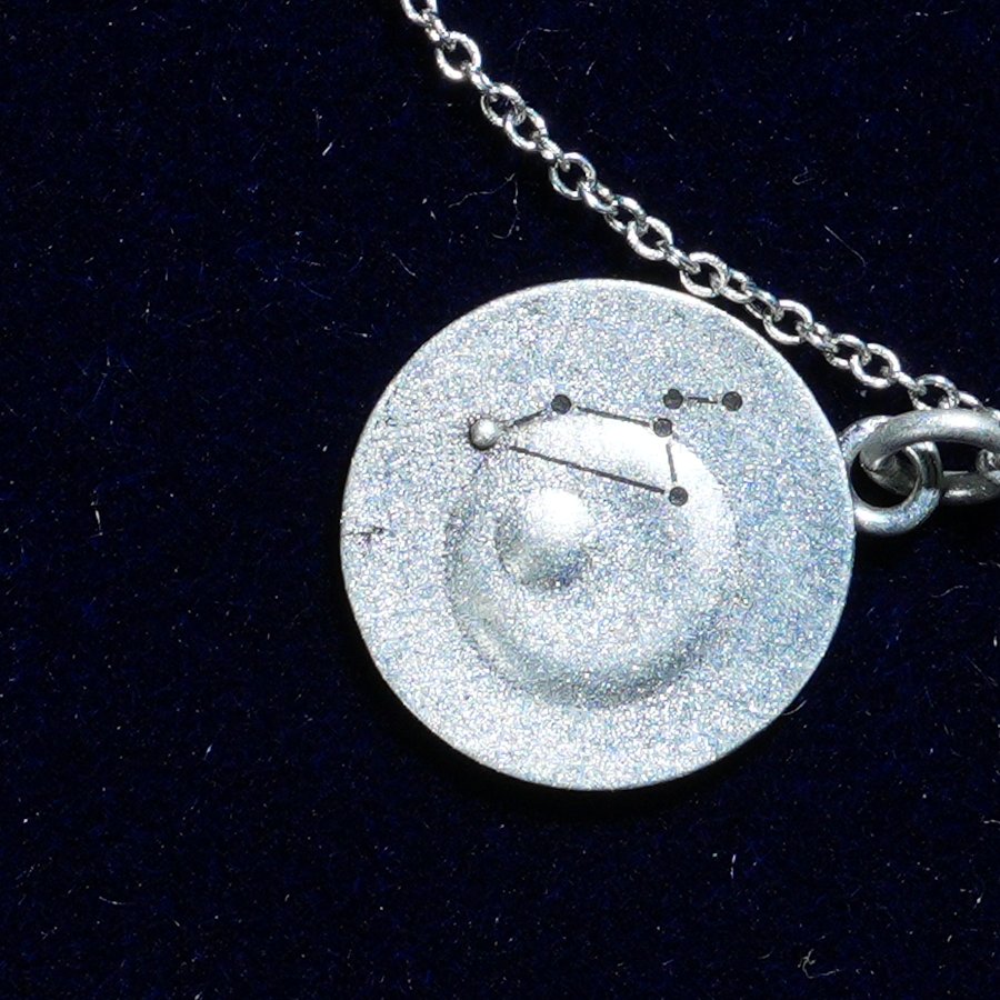 Coin of AV-0020, engraved with the Leo constellation, close up