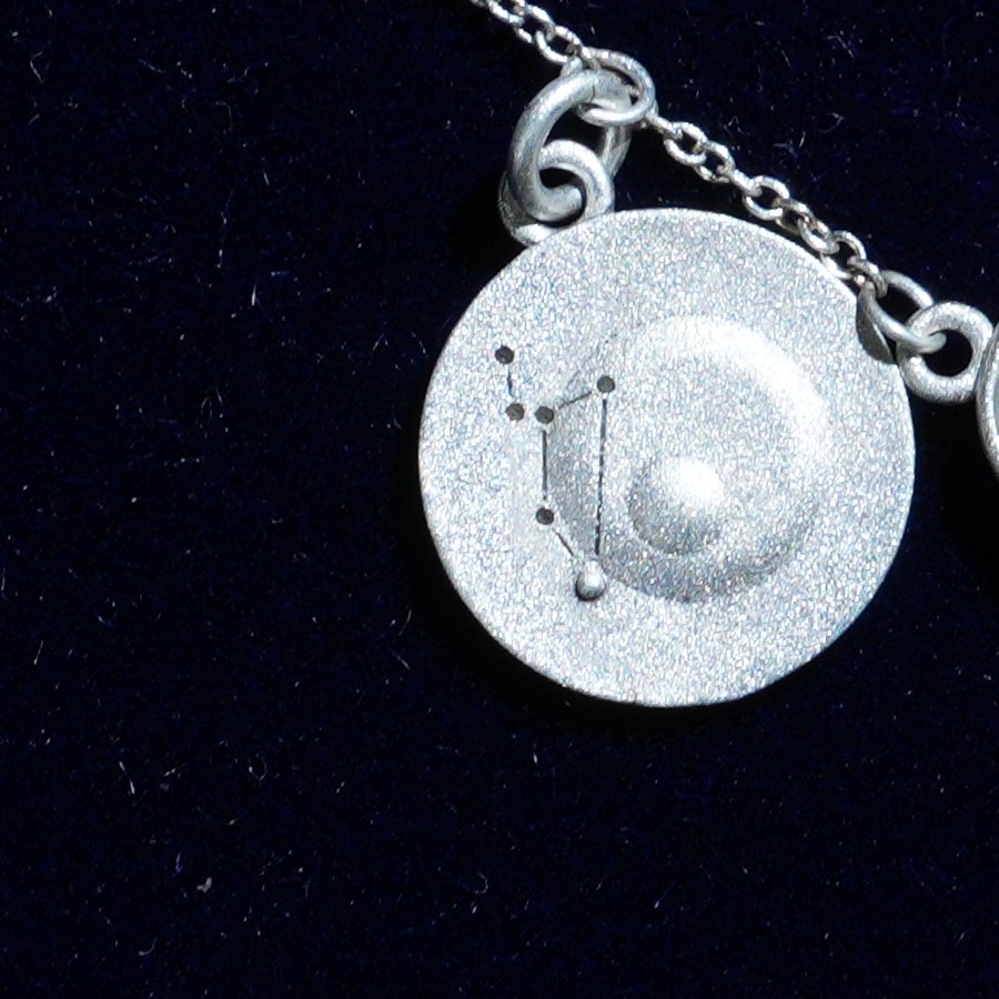 Coin of AV-0031, engraved with the Leo constellation, close up