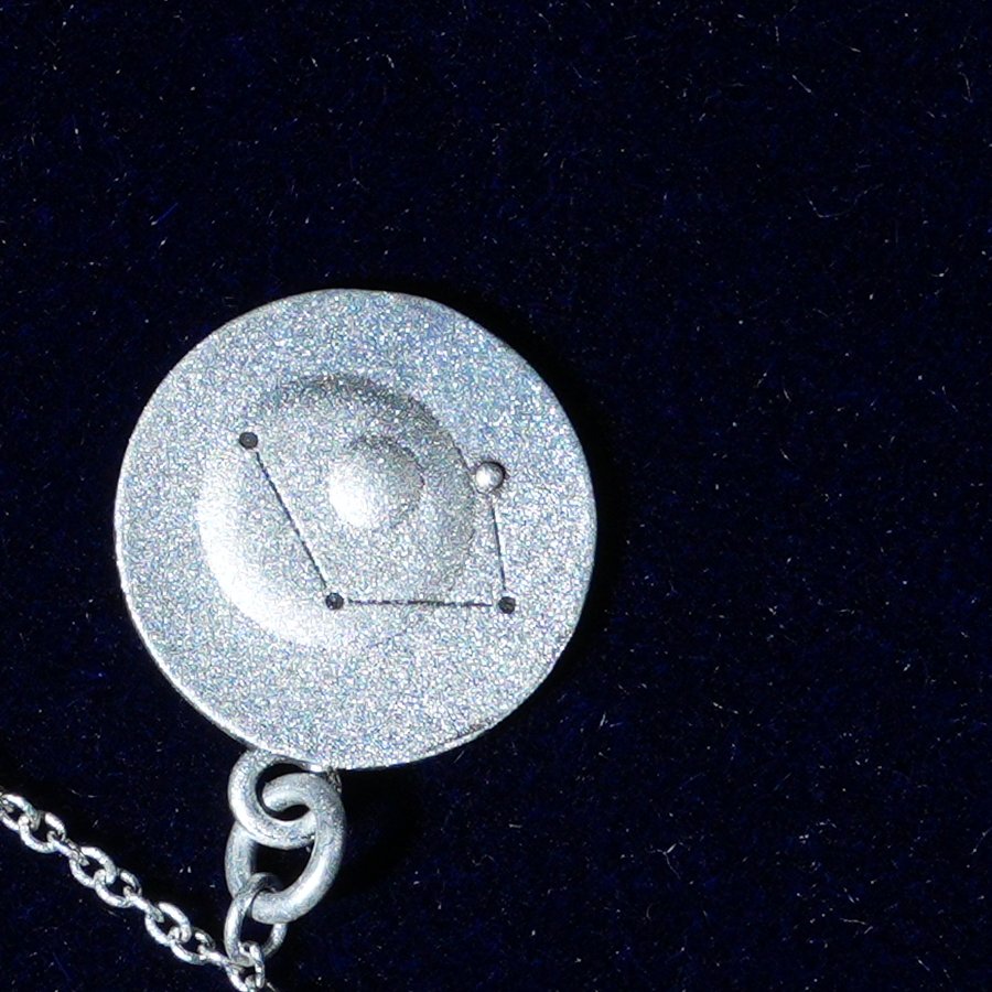 Coin of AV-0023, engraved with the Libra constellation, close up
