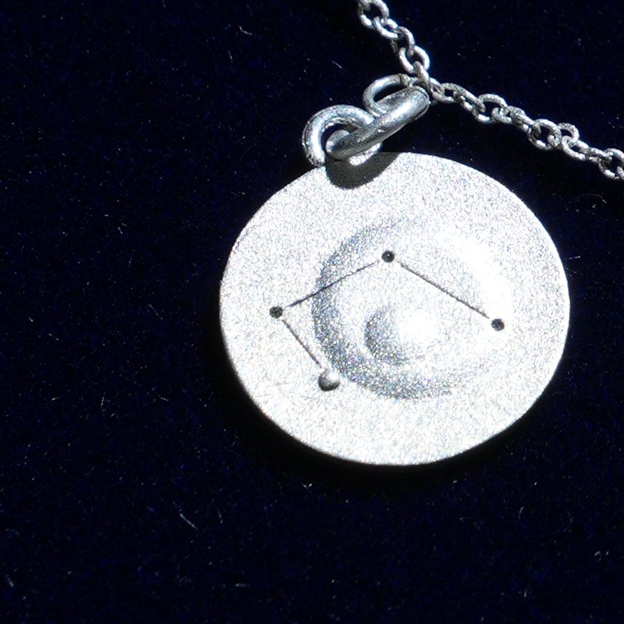 Coin of AV-0035, engraved with the Libra constellation, close up