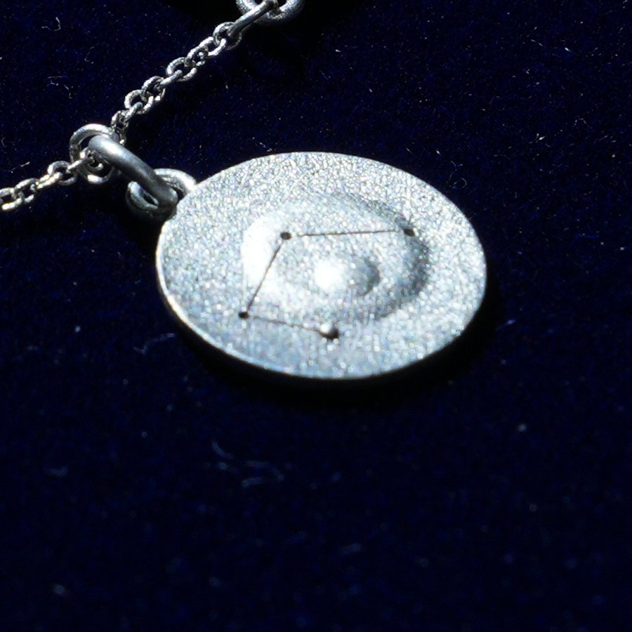 Coin of AV-0044, engraved with the Libra constellation, close up
