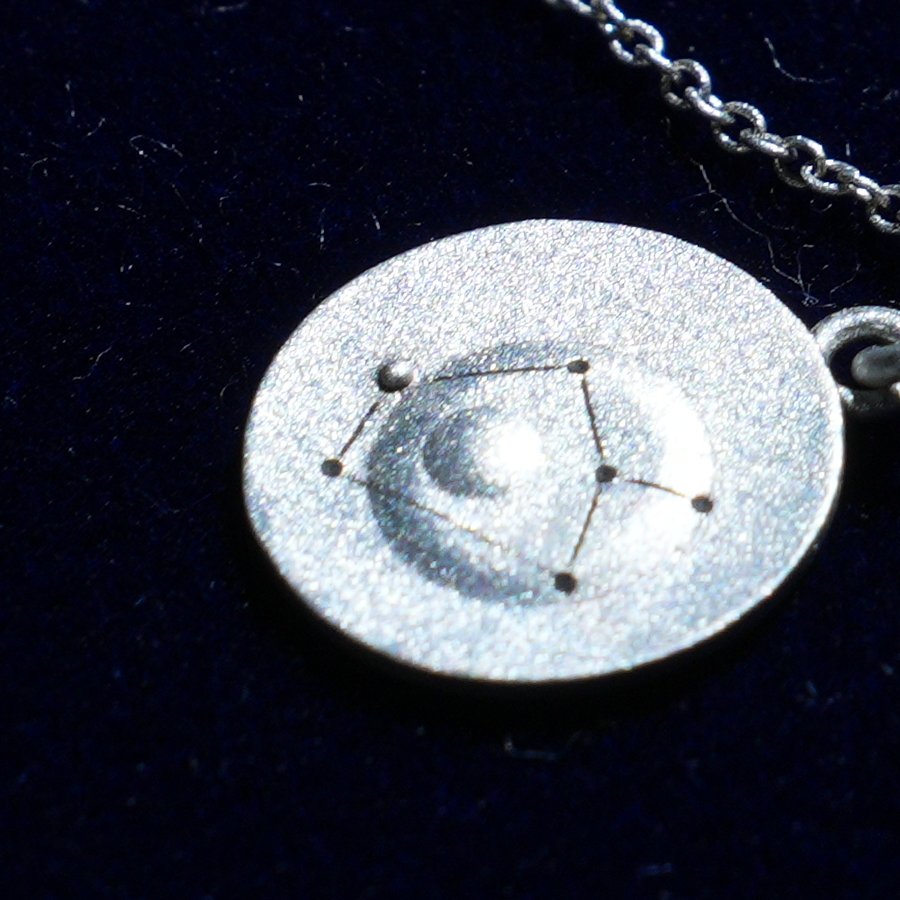 Coin of AV-0040, engraved with the Sagittarius constellation, close up