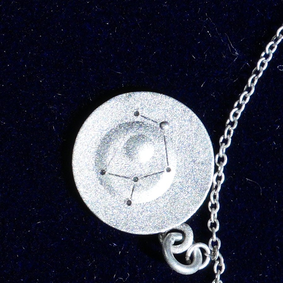 Coin of AV-0042, engraved with the Sagittarius constellation, close up