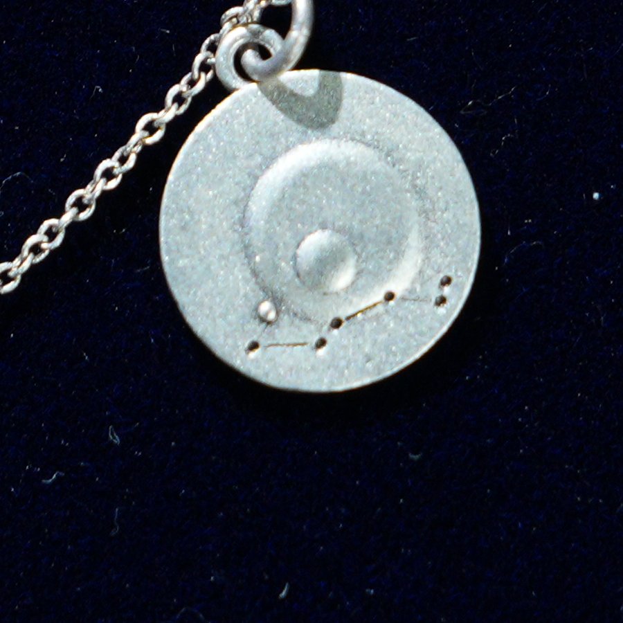Coin of AV-0008, engraved with the Scorpio constellation, close up