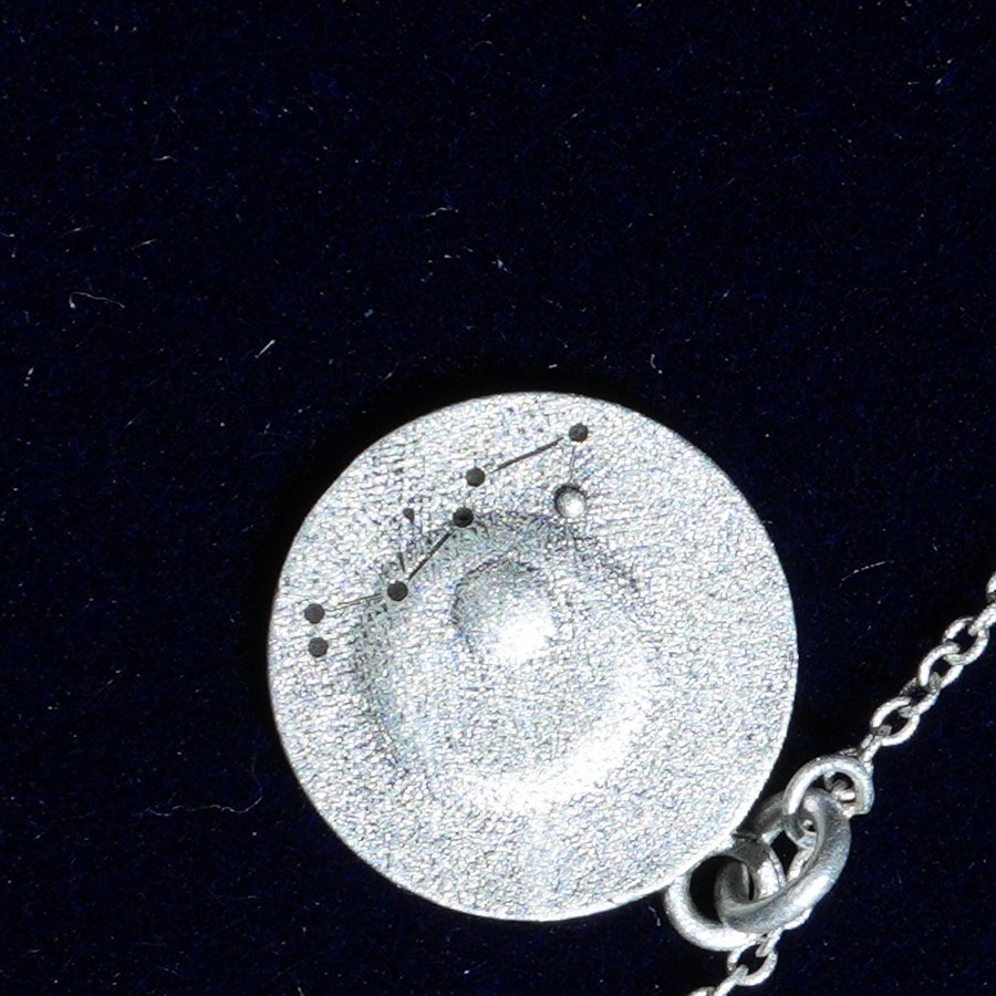 Coin of AV-0014, engraved with the Scorpio constellation, close up