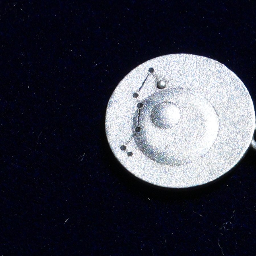 Coin of AV-0016, engraved with the Scorpio constellation, close up