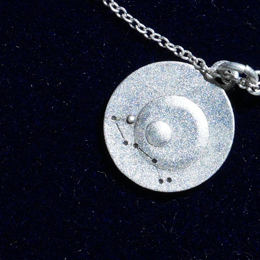 Coin of AV-0041, engraved with the Scorpio constellation, close up