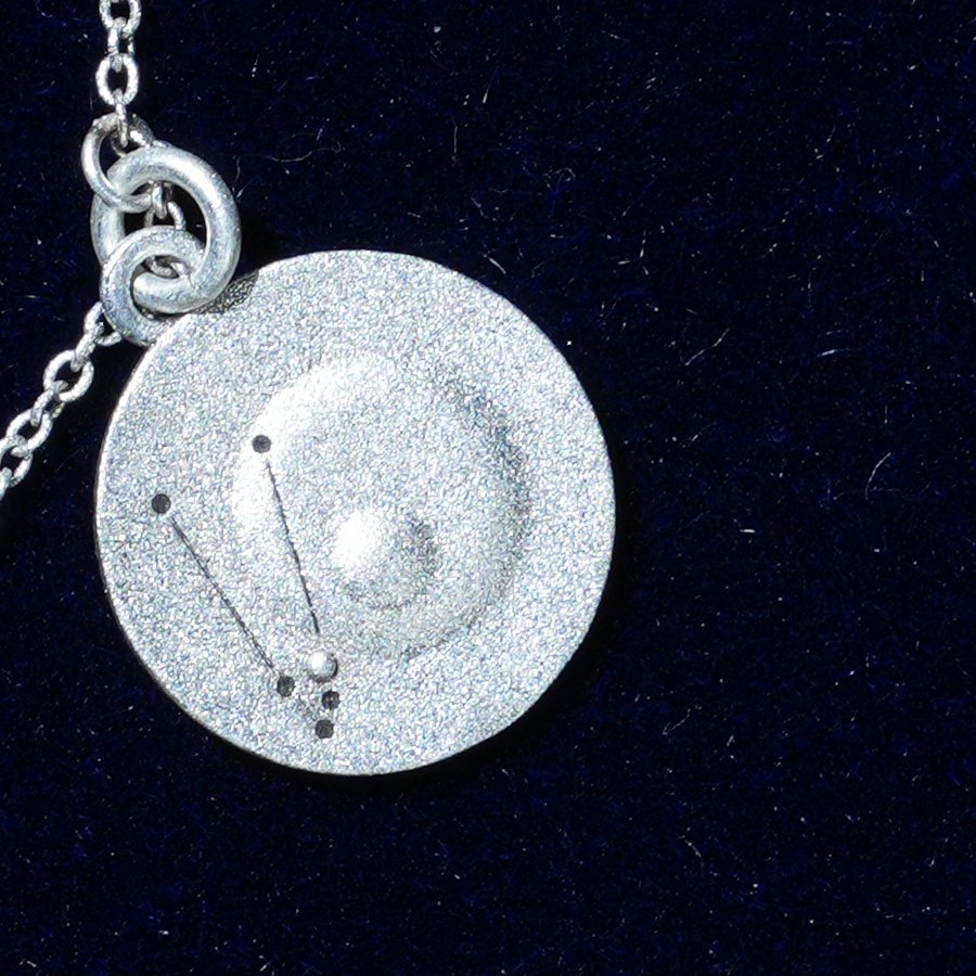 Coin of AV-0002, engraved with the Taurus constellation, close up
