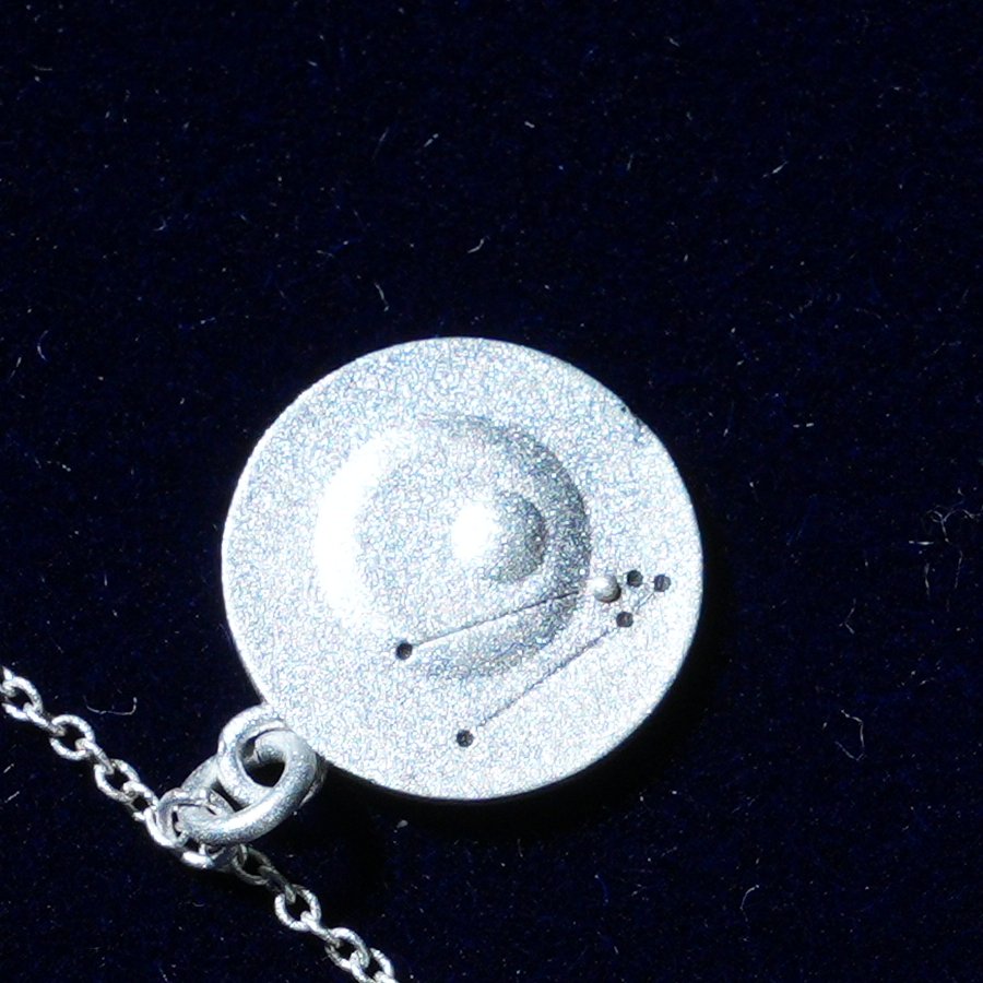Coin of AV-0026, engraved with the Taurus constellation, close up