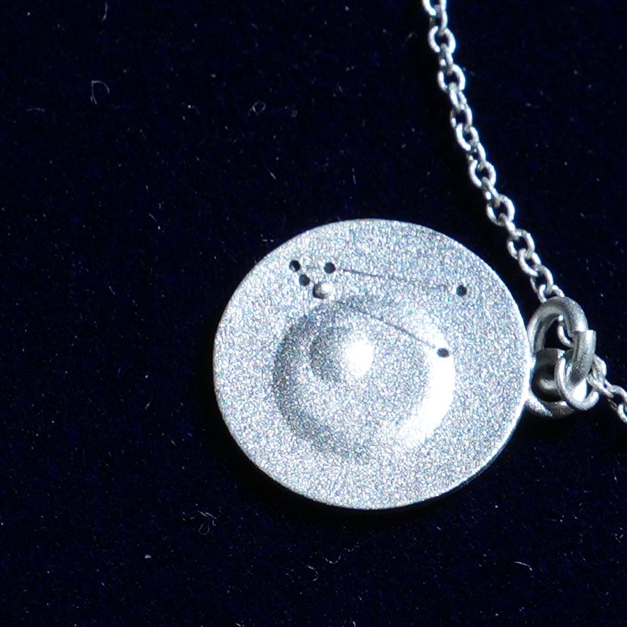 Coin of AV-0029, engraved with the Taurus constellation, close up