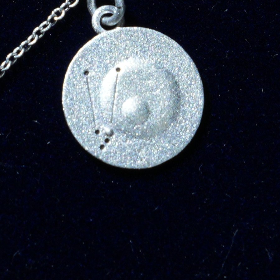 Coin of AV-0045, engraved with the Taurus constellation, close up
