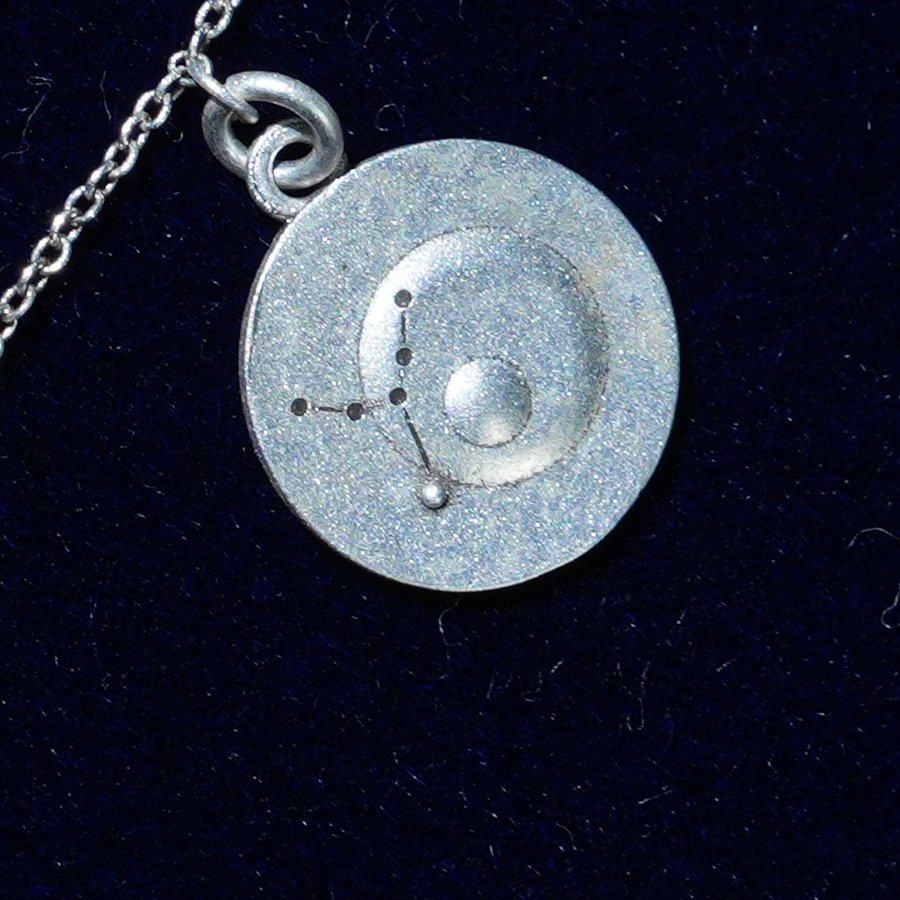 Coin of AV-0006, engraved with the Virgo constellation, close up