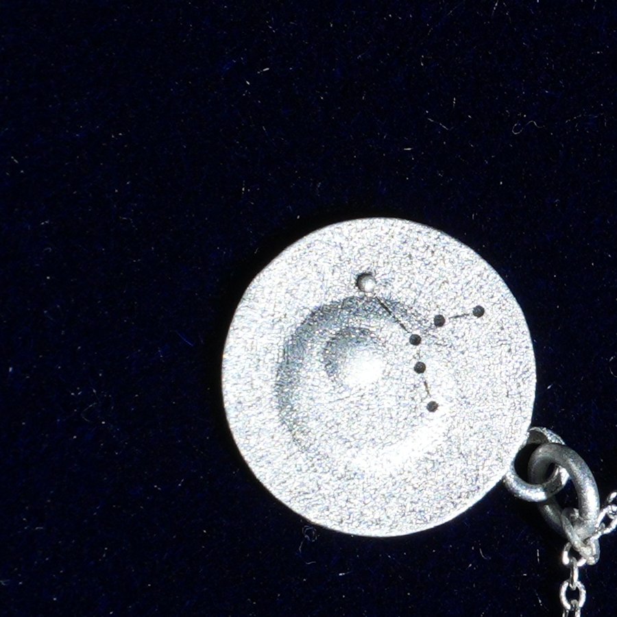 Coin of AV-0017, engraved with the Virgo constellation, close up