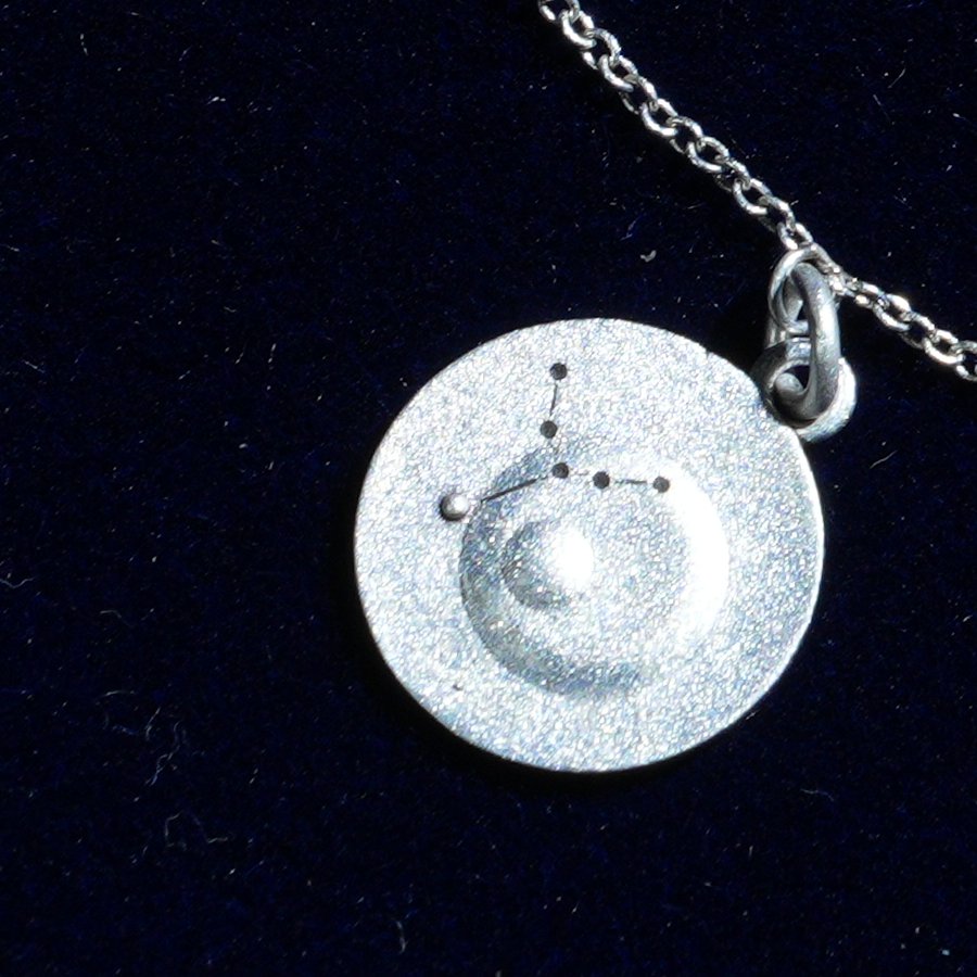 Coin of AV-0030, engraved with the Virgo constellation, close up